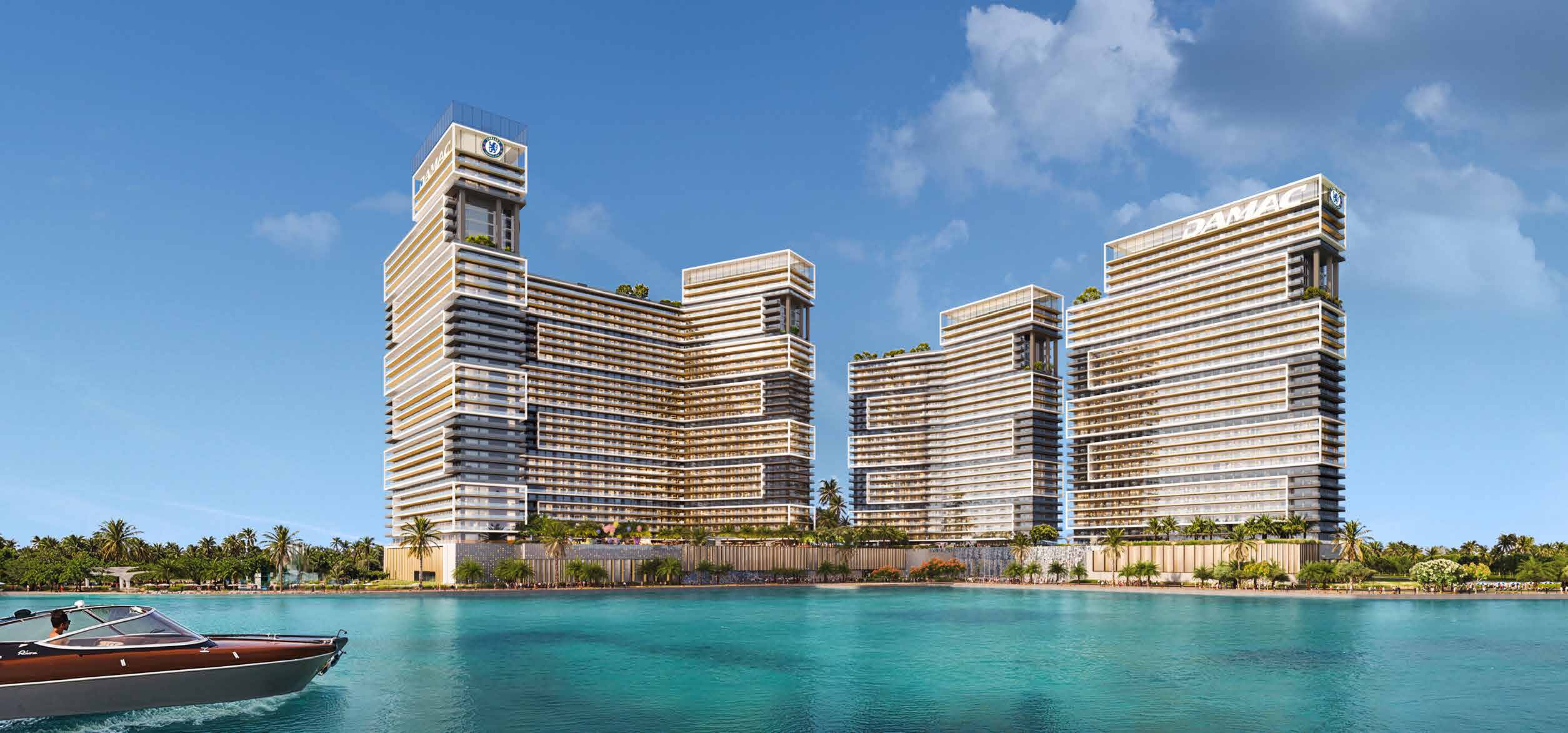 Chelsea Residences towers rising above palm trees and turquoise water