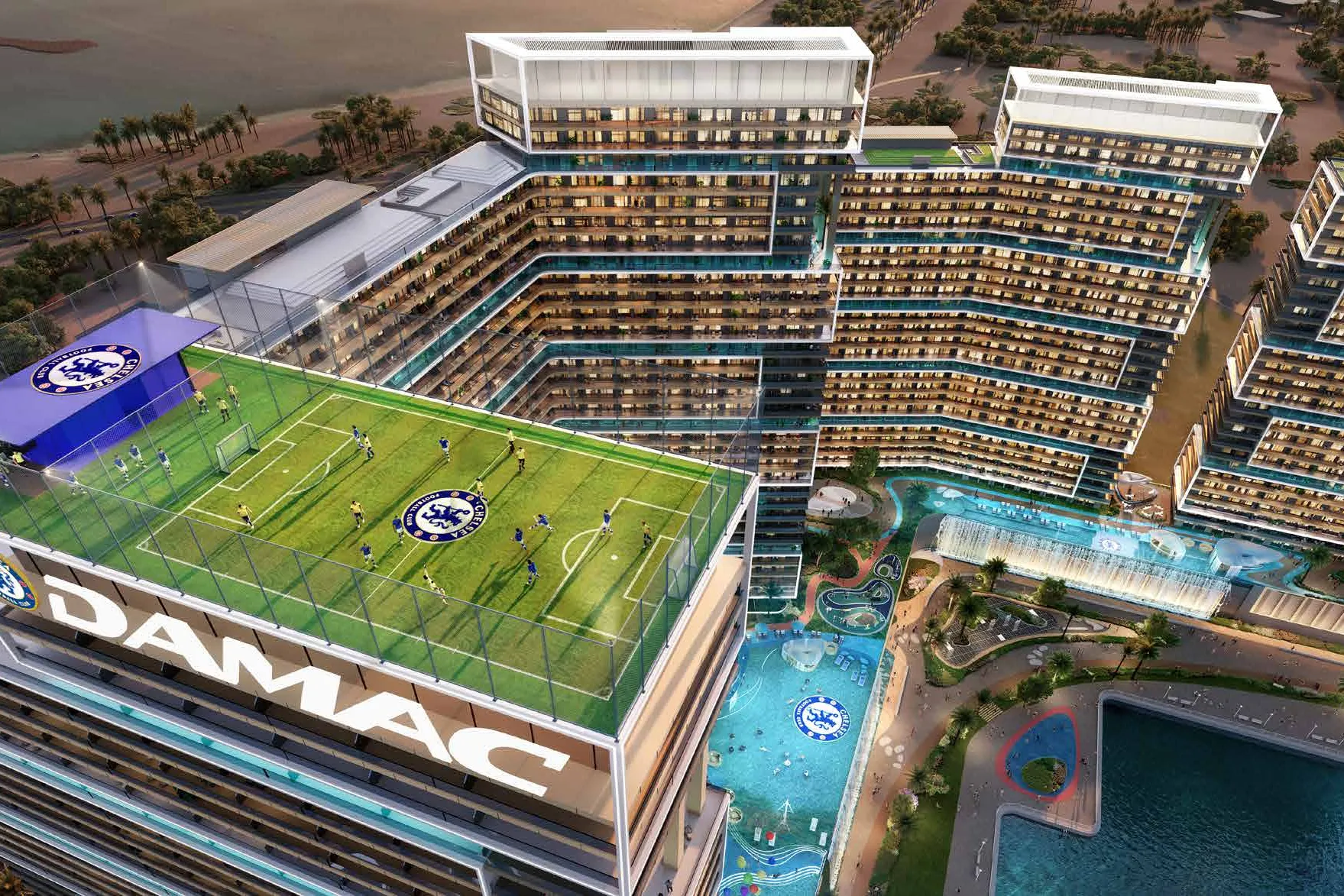 Rooftop football pitch crowning a tower, pools and towers below
