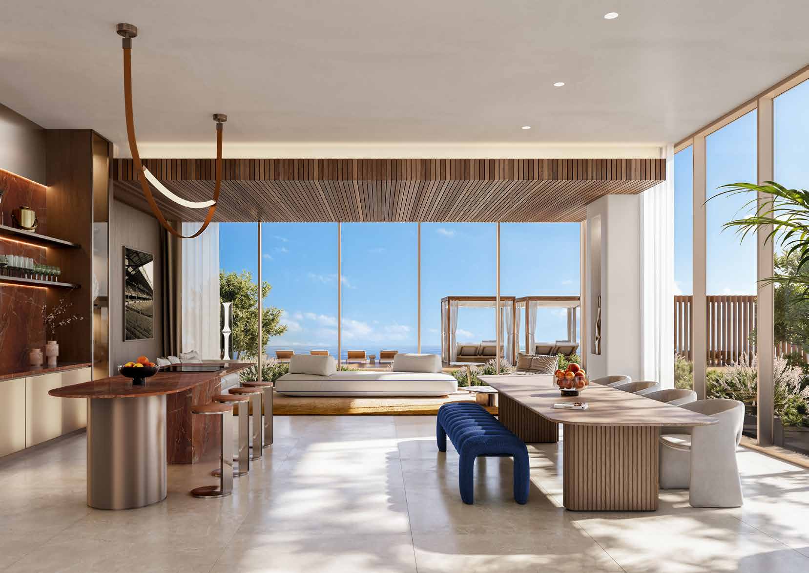 Sunlit dining room with long table, bar counter and terrace views