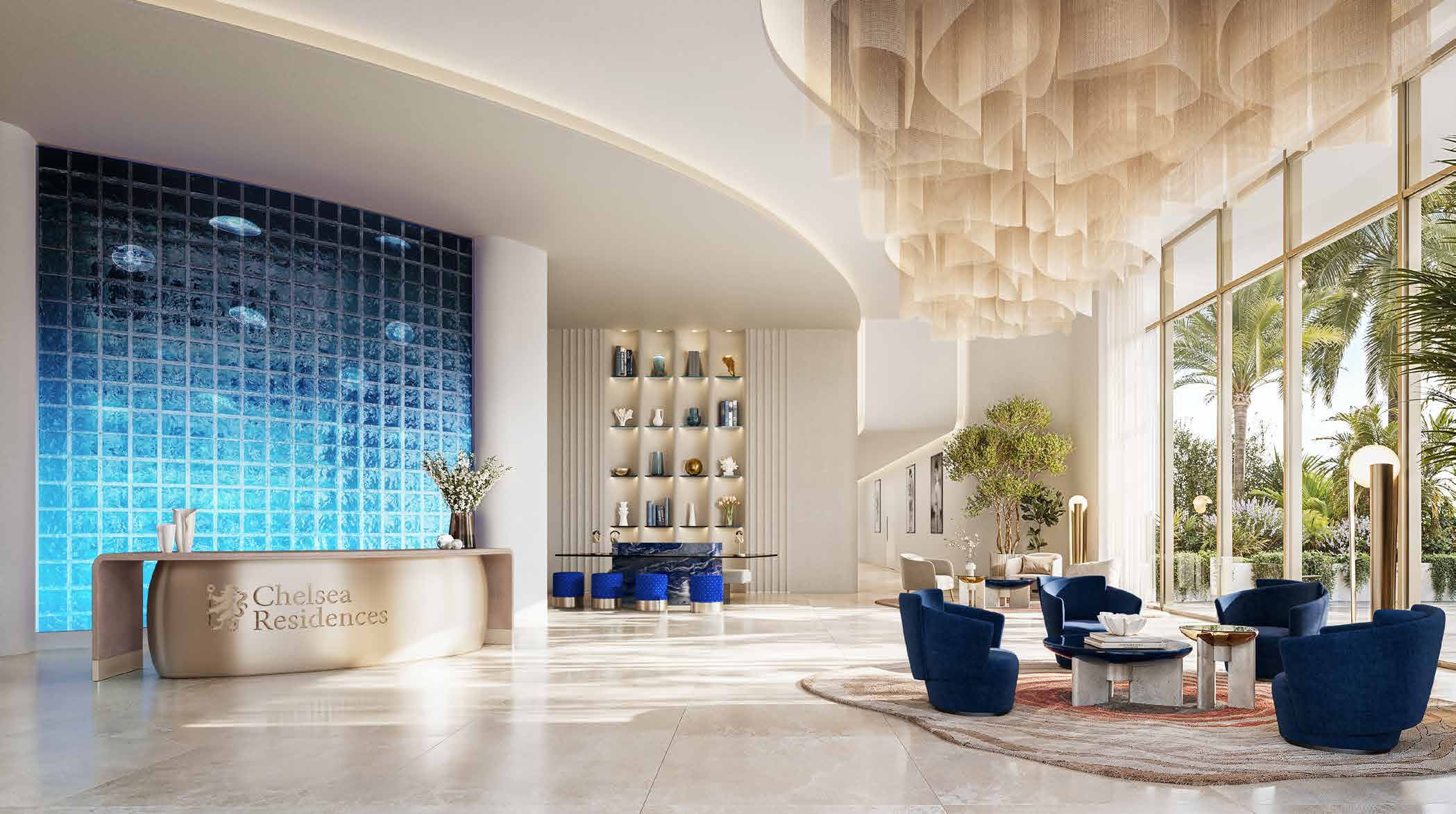 Bright lobby with blue glass wall, reception desk and navy armchairs