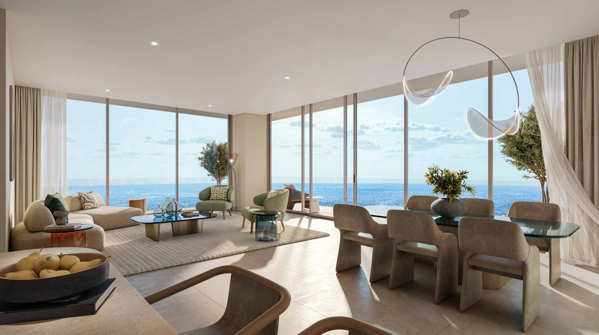 Open living and dining room with floor-to-ceiling windows onto the sea